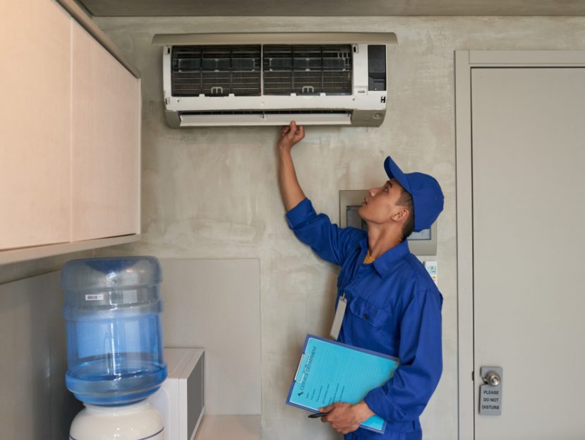 Air conditioning technician checking air conditioner
